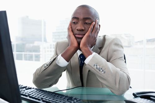 a person sitting in front of computer feeling bored